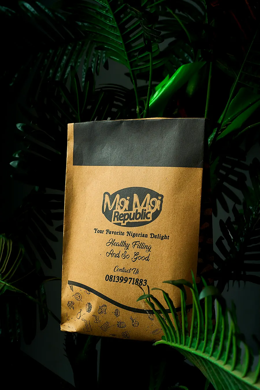 Moi Moi Republic kraft paper bag among green leaves